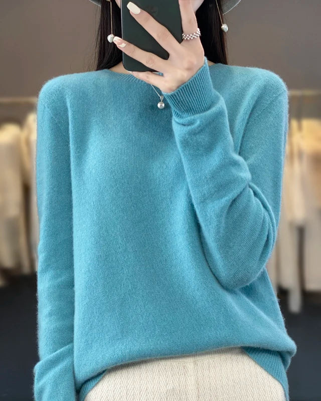 Women's Extrafine Merino wool round-neck sweater featuring a slim silhouette and 17.9-micron superfine fibre, crafted from pure Australian wool for breathable warmth and elegant layering in air-conditioned indoor settings.