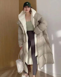 Layered-look hooded cotton-padded coat with contrasting inner detail, generous hood, long quilted shape and pockets, a warm fall-winter coat for commutes or relaxed winter plans.