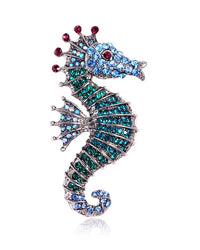 Diamond-set seahorse brooch in gold tone, whimsical marine pin with sparkling crystal accents and detailed curved body, perfect for adding ocean-inspired charm.