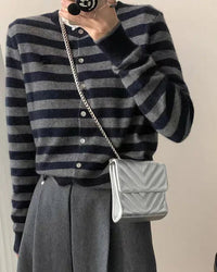 A heavyweight cashmere crewneck cardigan with crew neckline, single-breasted buttons and loose fit, designed for a cozy winter layering look that pairs from sneakers to boots.