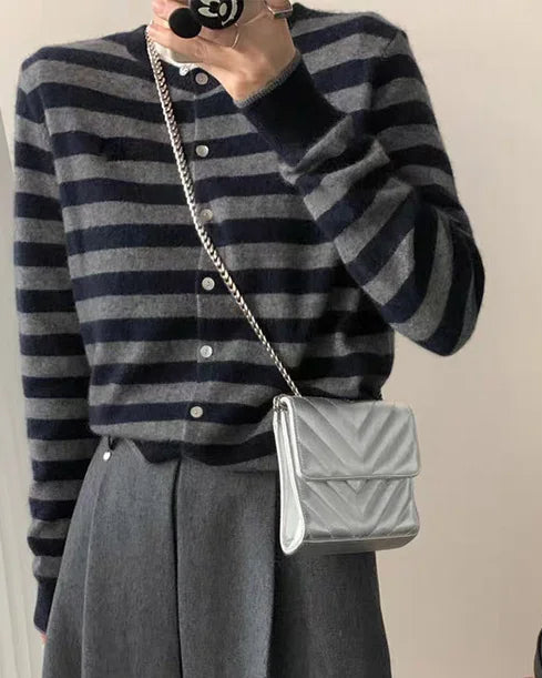 A heavyweight cashmere crewneck cardigan with crew neckline, single-breasted buttons and loose fit, designed for a cozy winter layering look that pairs from sneakers to boots.