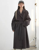 A cotton-Lyocell blend trench coat with a turn-down collar, single-breasted front and waist tie, designed for polished ease that layers from commute to weekend.