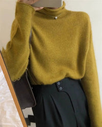 A relaxed wool turtleneck sweater with turtleneck, loose fit, long sleeves and stretch, designed for a cozy winter layering look that pairs from sneakers to boots.