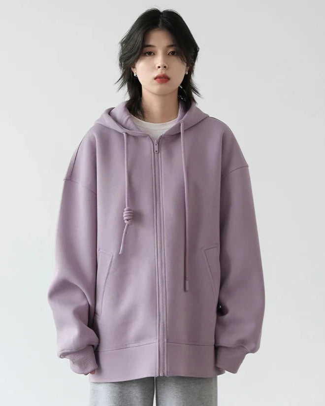 A long 80% cotton-blend hoodie with a zip front, drawstring hood and relaxed drop shoulders, designed for soft stretchy warmth that layers from commute to weekend.