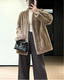 Faux mink fur solid V-neck pocket short coat. Thick, warm, and fluffy — a luxuriously elegant winter outerwear jacket for women.