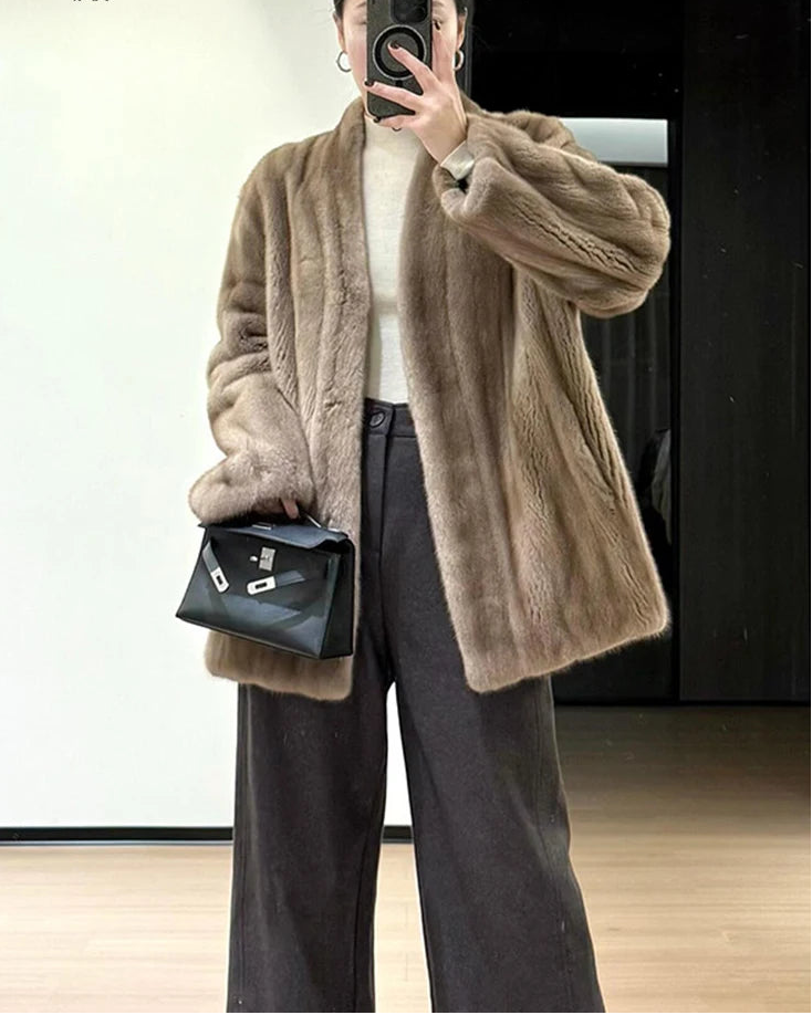 Faux mink fur solid V-neck pocket short coat. Thick, warm, and fluffy — a luxuriously elegant winter outerwear jacket for women.