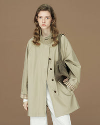 A short trench coat featuring a stand collar, a single-breasted front, and signature contrast cuffs for a modern, heritage-inspired look.