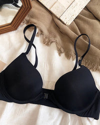Seamless front-closure push-up bra for women, made of polyester and spandex, with adjustable convertible straps and wire-free support for all-day comfort.
