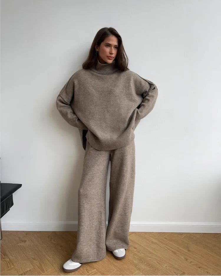 Turtleneck slit knit top and ankle-length trouser 2-piece set. Loose, solid-colour acrylic knit — casual office style for autumn and winter wear.