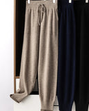 Women's Merino Wool high-waist knit trousers featuring a relaxed bloomer cut and thick knit texture, crafted from pure wool for breathable warmth and elegant layering in air-conditioned indoor settings.