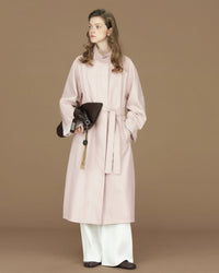 A long trench coat featuring a stand collar, a self-tie belt, and distinctive contrast cuffs for a refined, heritage-inspired look.