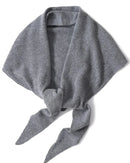 An oversized 100% wool triangle wrap shawl with a soft knitted texture, designed to drape elegantly over coats and knits for versatile warmth.