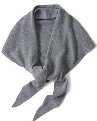 An oversized 100% wool triangle wrap shawl with a soft knitted texture, designed to drape elegantly over coats and knits for versatile warmth.