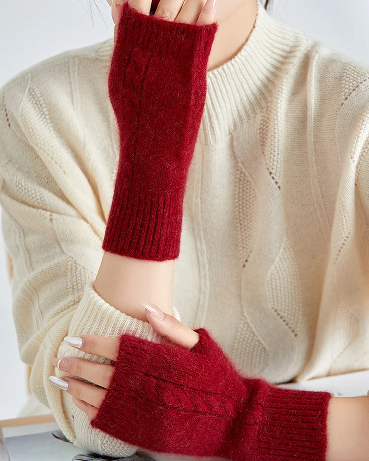 Women's fingerless knit wrist warmers made from a soft raccoon hair and wool blend. Thumb hole design for all-day comfort. Perfect for fall and winter layering.