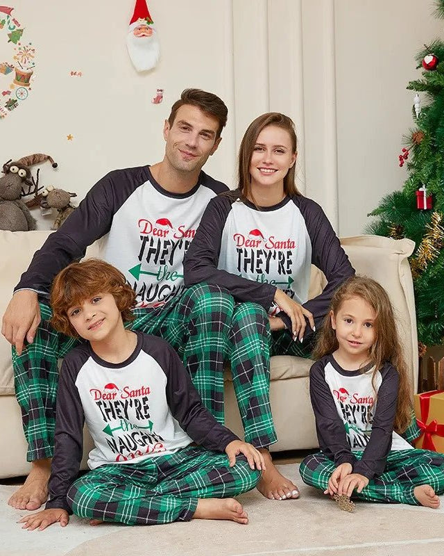 Family matching Christmas pajamas set featuring long-sleeve raglan tops with the text "Dear Santa, They're the Naughty Ones" and green plaid pants. This cute cartoon print sleepwear set is made from a soft polyester-rayon-spandex blend and is available in sizes for father, mother, kids, baby, and even dog.