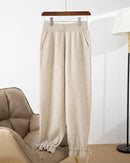 A merino wool cuffed knit pants with high elastic waist, pockets, seamless knit, elastic cuffs and stretch, designed for a cozy winter layering look that pairs from sneakers to boots.
