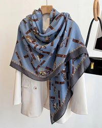 A luxury printed square shawl and beach wrap featuring a retro design, a lightweight polyester construction, and a generous 130x130cm drape.