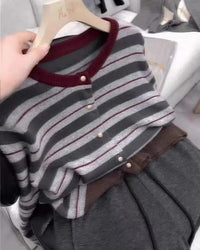 Model wearing a lightweight, loosely fitted knit cardigan made from pure cashmere, featuring elegant vertical stripes for a chic, relaxed look.