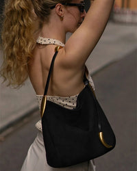 A large-capacity suede tote bag designed to be carried under the arm, offering both a stylish and practical everyday accessory.