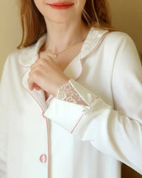 Woman lounging in sand-beige turn-down-collar two-pieces pajamas, soft cotton-linen blend and relaxed notch lapels give coastal spa vibes—your breathable 70-85 °F summer sleep set.