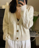  Woman layering a sand-beige V-Neck Cashmere Knitted Cardigan, 19-micron Mongolian fibers and mother-of-pearl buttons give luxe polish—your breathable 60-75 °F spring-fall layer.