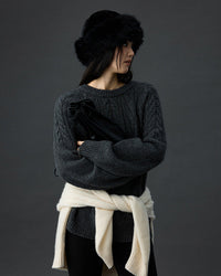 Choice: Woman ice-skating in cream wool cable-knit pullover, chunky shoulder braids and ribbed cuffs lock in heat for cozy winter outings .