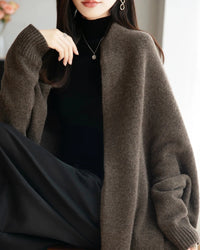 Women’s merino-wool fringed shawl with loose long-sleeve cut and flowing silhouette—statement wrap for autumn offices, weekend cafés or travel-layering chic.