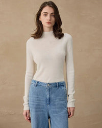 Semi-roll neck sweater in soft camel, lightweight cashmere blend and elongated cuffs tuck effortlessly into high-waist trousers or skirts.