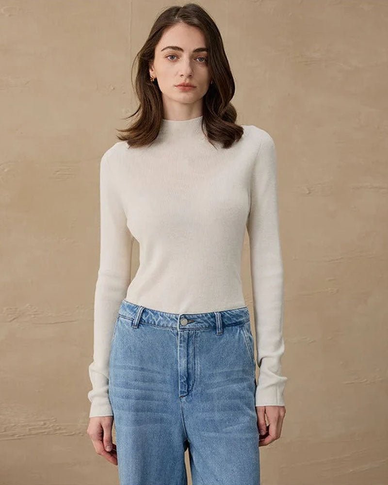 Semi-roll neck sweater in soft camel, lightweight cashmere blend and elongated cuffs tuck effortlessly into high-waist trousers or skirts.