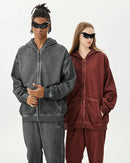 Woman street-styling a zipper-washed-distressed oversized cotton hoodie, 420 g acid-wash fleece and raw-edge rips give lived-in 90s attitude—your cozy yet breathable 60-75 °F spring-fall layer.