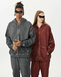 Woman street-styling a zipper-washed-distressed oversized cotton hoodie, 420 g acid-wash fleece and raw-edge rips give lived-in 90s attitude—your cozy yet breathable 60-75 °F spring-fall layer.