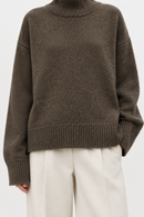 Brown cashmere turtleneck sweater cuff and hem detail