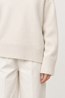 White cashmere turtleneck sweater cuff and hem detail