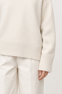 White cashmere turtleneck sweater cuff and hem detail